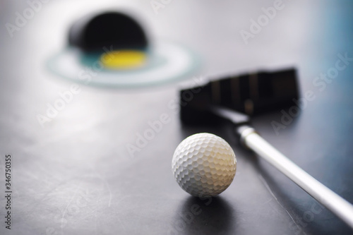 Sport and healthy lifestyle. Mini golf. White golf ball and set for minigolf on the table. Sports background with golf concept.