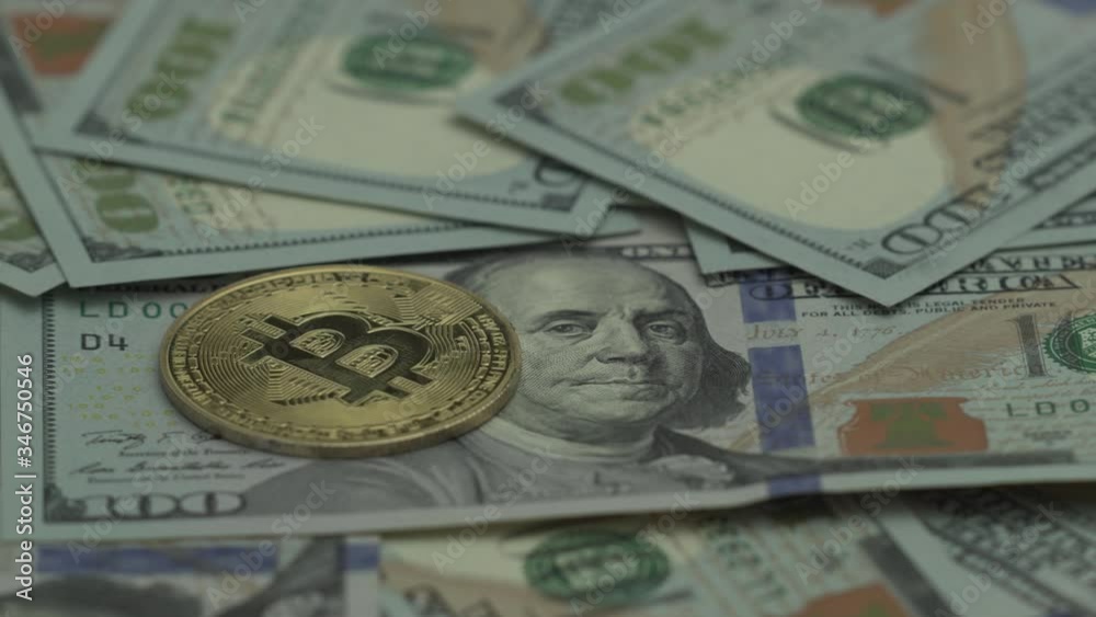 Gold cryptocoin Bit Coin BTC is laying the table with many bills of 100 US dollar. Clow panorama from right to left. Money of the future. Halving time Gold cryptocoin Bit Coin BTC is laying the table with many bills of 100 US dollar. Clow panorama from right to left. Money of the future. Halving time