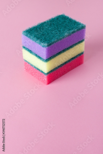 Kitchen cleaning sponge on pink background. Stack of sponges with copy space. 