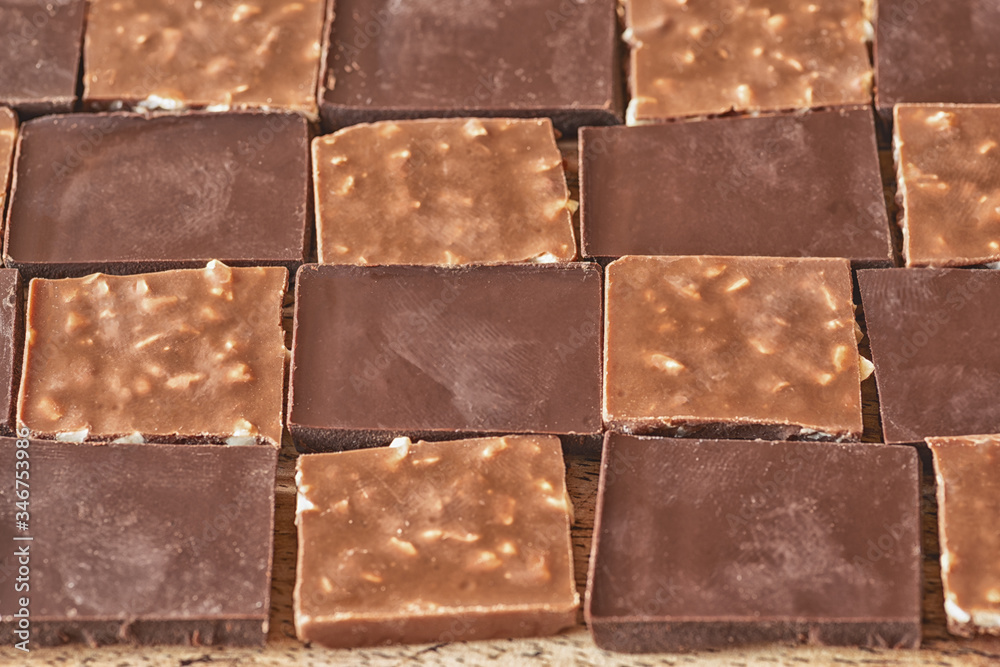 Fototapeta premium pieces of different milk chocolate are carefully laid out in a staggered order