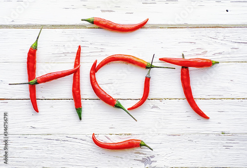 Hot red pepper on a white wooden vintage background.