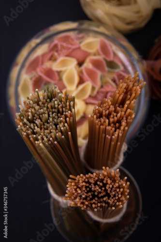 Conchiglie pasta and some bonds of linguine pasta. photo