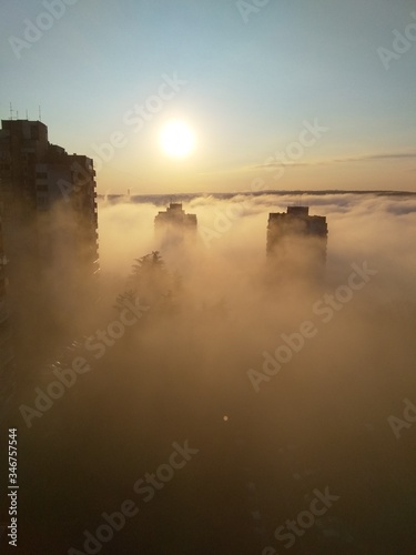 Aerial view of buildings in dense fog - clouds over Belgrade, Serbia