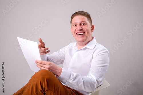 A man with documents of emotion and joy is sitting