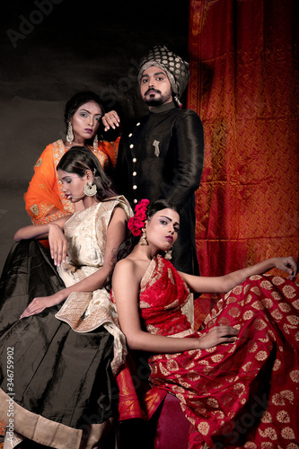 indian models in indian ethnic Saree, Lehenga and male model in a black sherwani