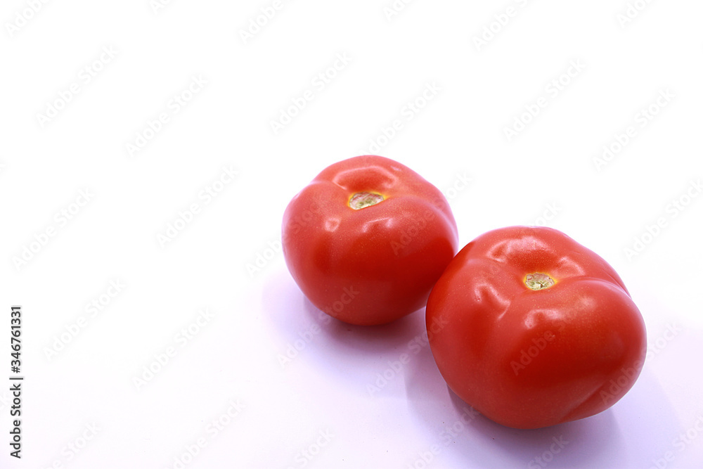 Photo of red tomatoes on a white background, close-up Photo of red tomatoes on a white background, close-up