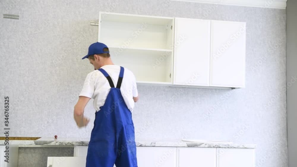 cabinet shelf installation. Worker assembling furniture cabinet shelf installation. Worker assembling furniture