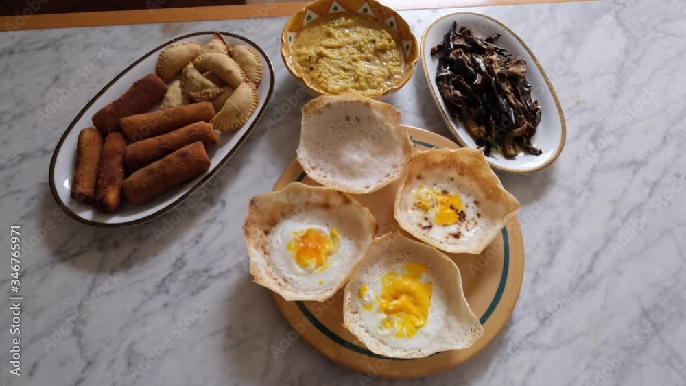 Homemade srilankan dishes, egg hopper,samosas and eggplantts with sugar and curry Homemade srilankan dishes, egg hopper,samosas and eggplantts with sugar and curry