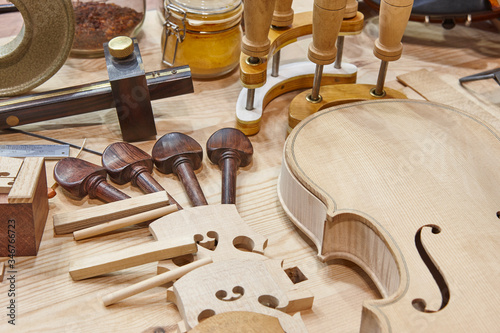 Luthier workshop with violin parts and tools. Traditional craftmanship. photo