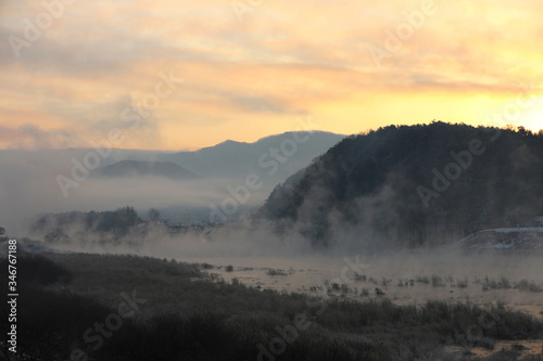 Winter morning sunrise landscape of water misty rivers and mountains. Soyang River, Chuncheon City, Korea