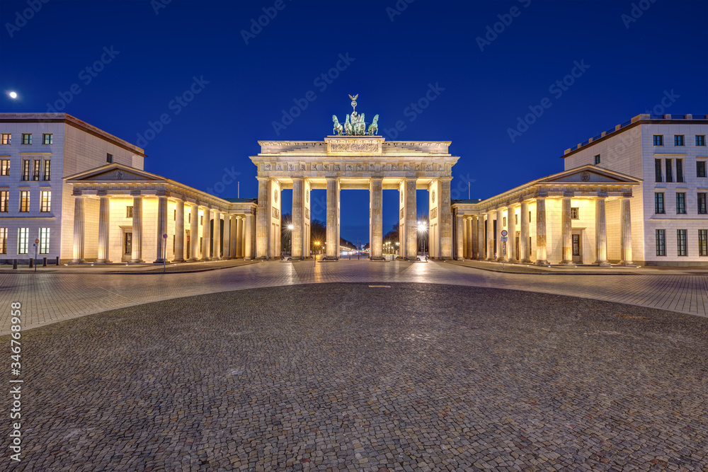 Panorama of the famous illuminated Brandenburg Gate in Berlin at night with no people