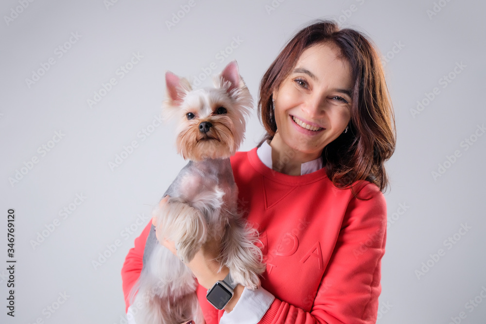 Girl with a dog on a light background Girl with a dog on a light background