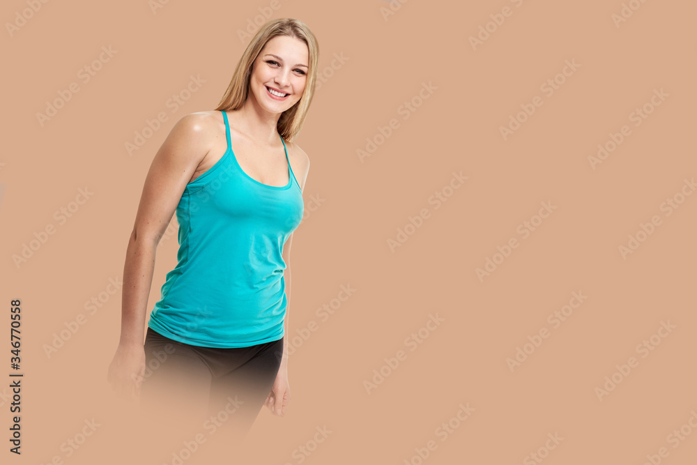 fitness woman. Young sporty Caucasian female model isolated on background salmon shade red