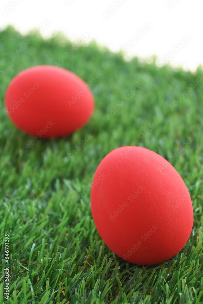red easter egg on lawn green grass artificial, image of morning springtime concept