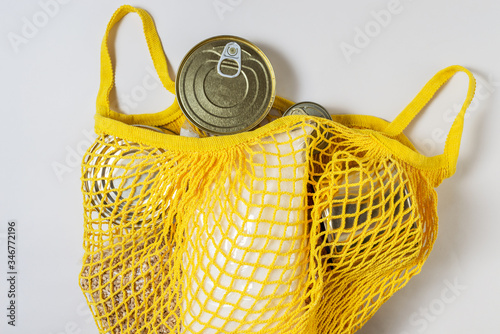 A set of long-term storage products in a string bag on a white background. Food donations or food delivery concept