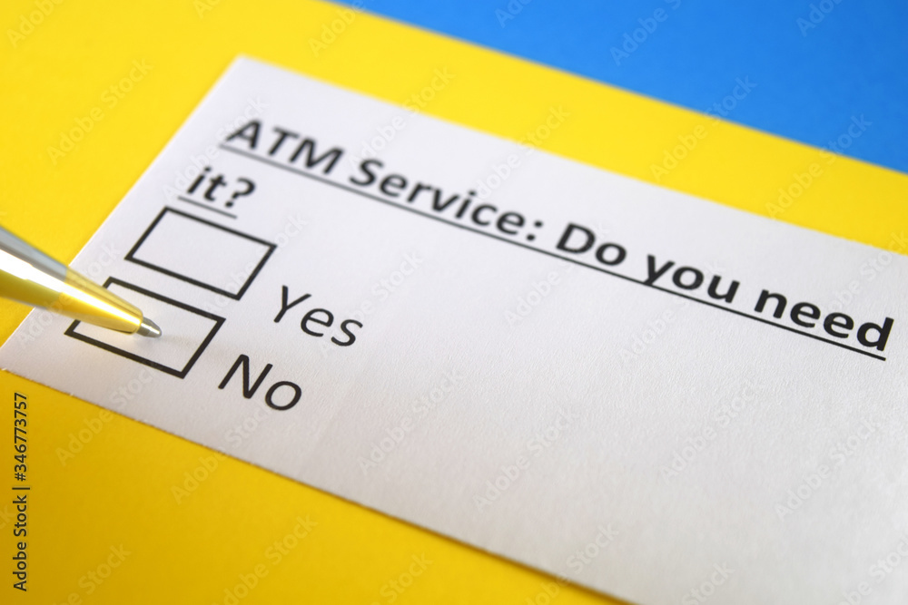 One person is answering question about ATM service. One person is answering question about ATM service.