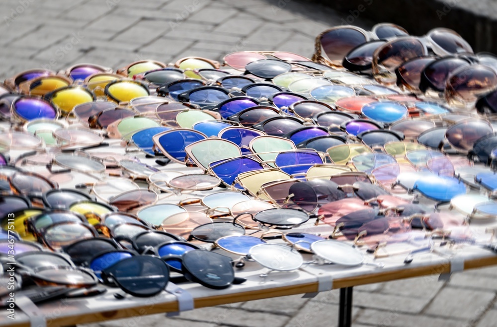 Marketplace in Southern Italy with a lot of counterfeit fake sunglasses and swirl effect focused on middle of the image