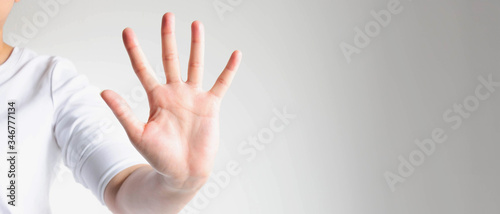 Close-up of a hand palm showing five fingers; the hand signs telling to stop and warning to do not do something.
