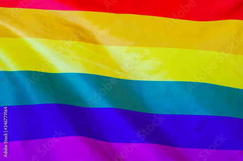 Fabric texture flag of LGBT gay. Flag of LGBT gay waving in the wind. LGBT gay flag is depicted on a sports cloth fabric with many folds. Sport team banner.