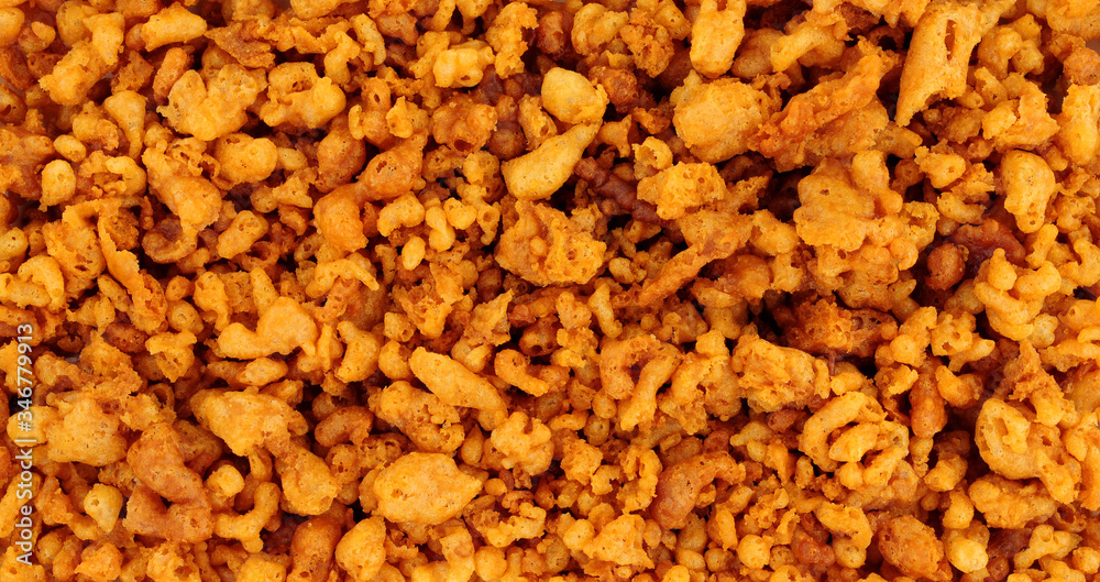 Batter scraps background texture, also known as batter bits or dubs, they are pieces of deep-fried batter left over in the fryer as a by-product of frying fish, and are served as an accompaniment to c Batter scraps background texture, also known as batter bits or dubs, they are pieces of deep-fried batter left over in the fryer as a by-product of frying fish, and are served as an accompaniment to c