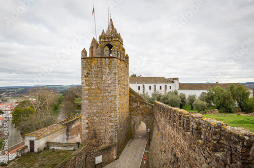 Clock tower and the village gate (Santarém gate) - castle of Montemor-O-Novo, District of Evora, Alentejo, Portugal photo