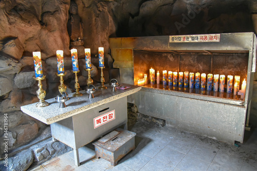 Busan city, South Korea - NOV 01, 2019: In the basement of Guanyin stone statues, people will take the water here for drinking in Haedong Yonggung Temple. photo