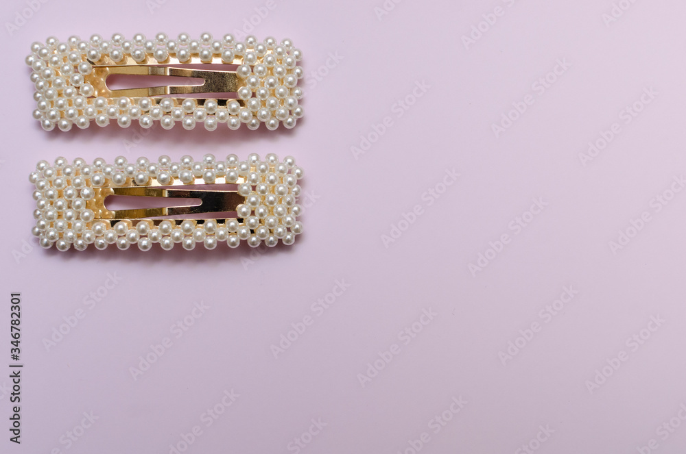 hair pins with pearls on a pink background hair pins with pearls on a pink background