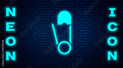 Glowing neon Classic closed steel safety pin icon isolated on brick wall background. Vector Illustration