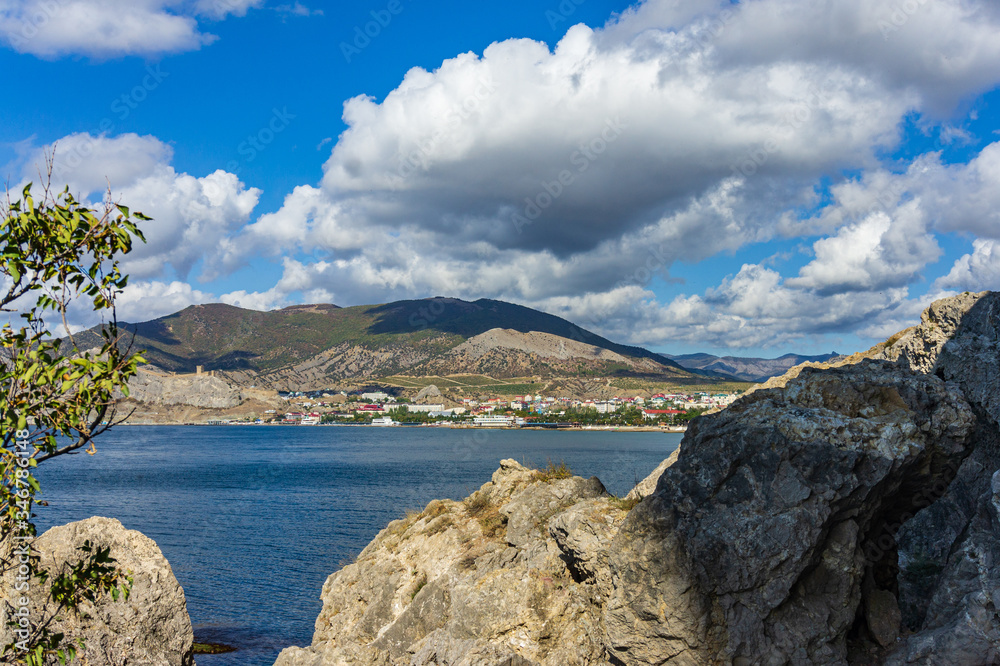 View of fortress wall of  Genoese fortress from Cape Alchak. Oldest tourist attractions of resort town is located on steep cliffs emerging from depths of sea. Sudak, Crimea, Russia - October 2, 2019.