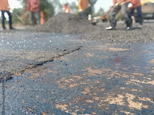 Road maintenance work using human labor (blurred image)