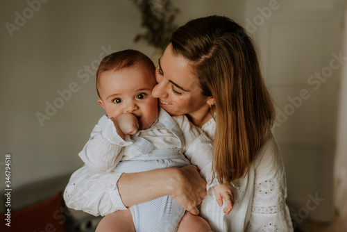 young smiling mother with baby in her arms