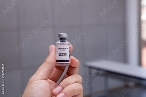 Close-up on Laboratory Tube Virus corona covid 19 vaccine. Scientist research for new novel corona virus immunization drug concept. Coronavirus COVID-19 vaccine vial and injection syringe.