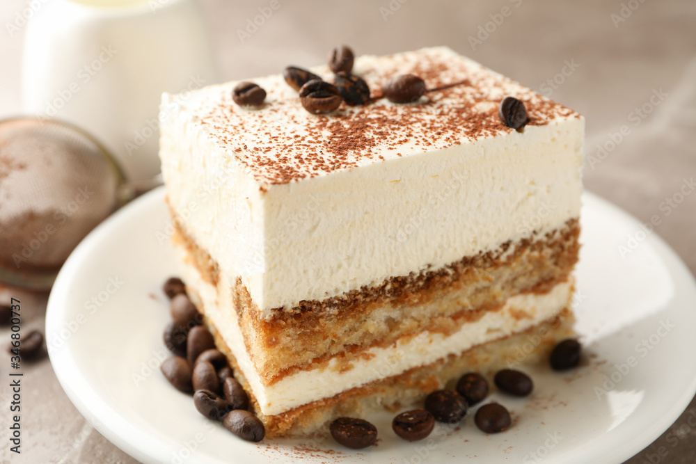 Composition with plate of tiramisu on light brown background. Tasty dessert Composition with plate of tiramisu on light brown background. Tasty dessert