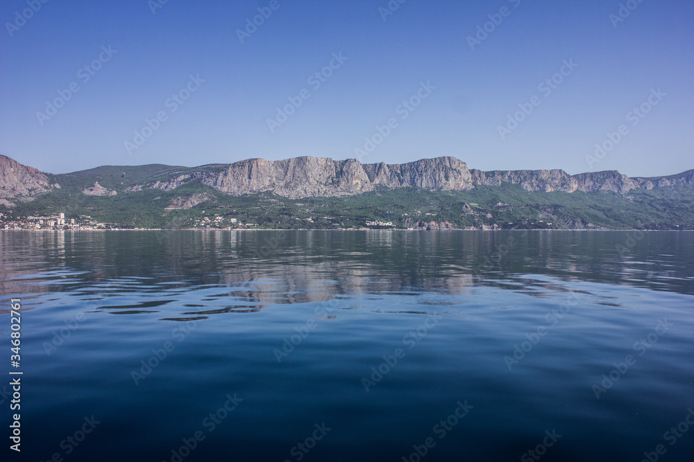 Scenery on the blue sea and mountains in the morning in clear weather.