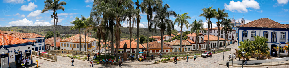 Panorama of traditional houses and palm tree lined street in historic center of Diamantina on a sunny day, Minas Gerais, Brazil
