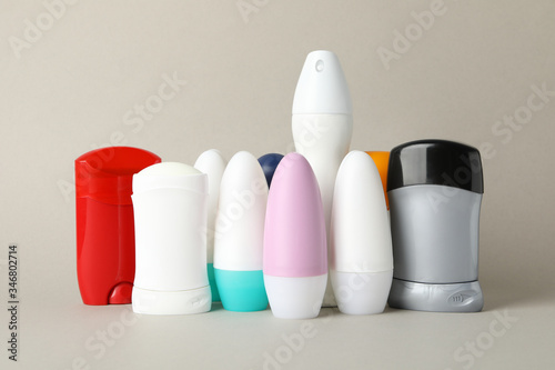 Group of body deodorants on gray background, blank space for text