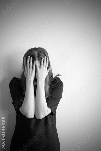 Monochrome portrait of young beautiful woman in depression