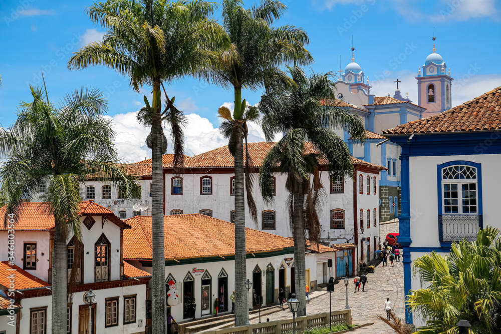 View to traditional houses and palm tree lined street in historic center of Diamantina on a sunny day, Minas Gerais, Brazil View to traditional houses and palm tree lined street in historic center of Diamantina on a sunny day, Minas Gerais, Brazil