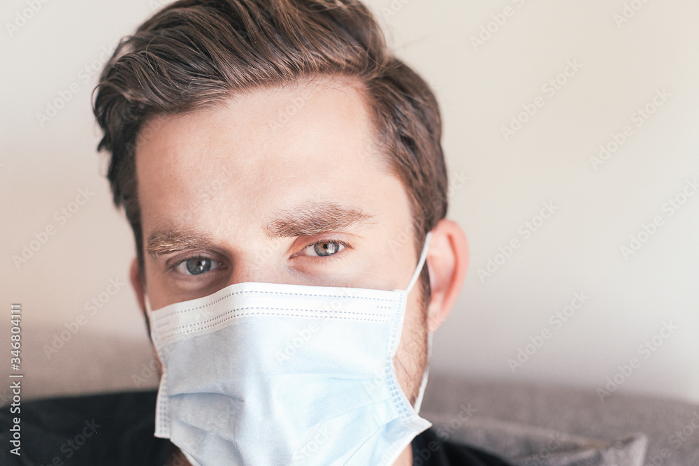 Close up portrait of a handsome serious sad man in medical mask Close up portrait of a handsome serious sad man in medical mask