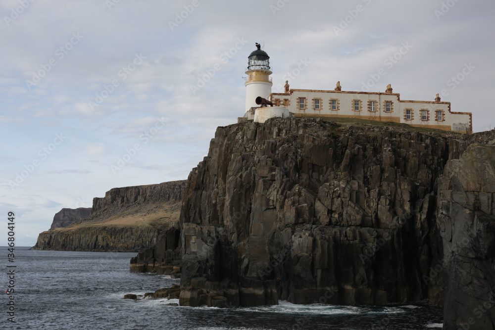 A lighthouse located on a rugged coastline.