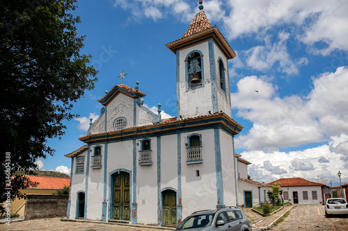 View to historic church and buildings in white and blue against blue sky and white clouds, green tree, Diamantina, Minas Gerais, BrazilDiamantina, Minas Gerais, Brazil
 photo