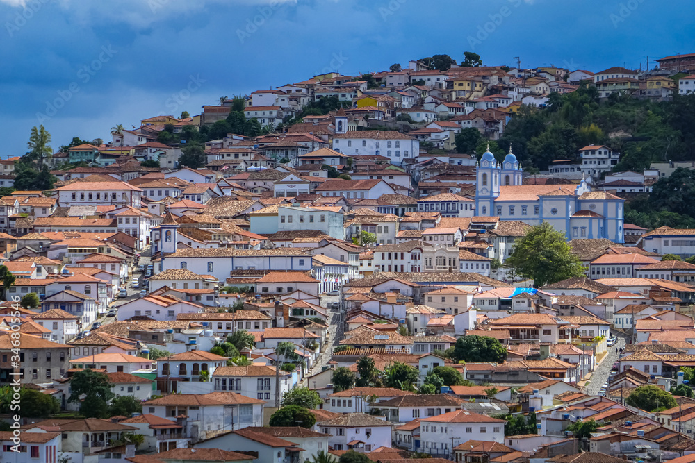 Close up aerial view with sunshine, shadow and clouds to the historic town center of Diamantina, Minas Gerais, Brazil