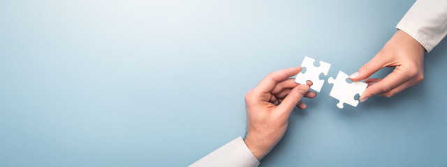 People holds in hand a jigsaw puzzle. Business solutions, success and strategy.