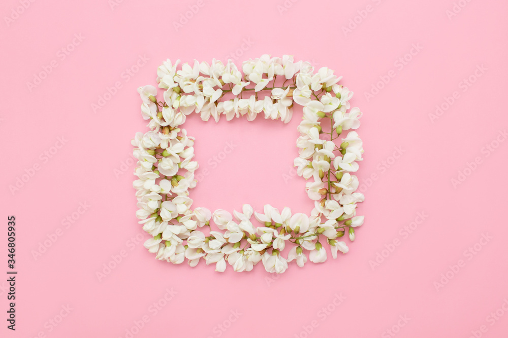 Creative layout with white flowers on a light pink background. Minimal idea of love of nature. The concept of spring flowers.