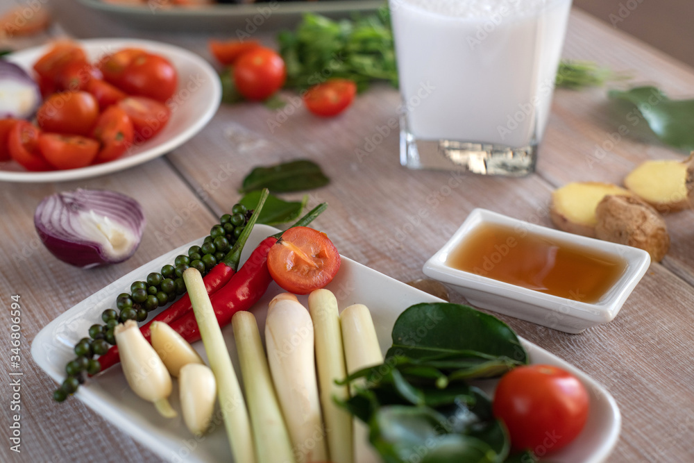 Cooking tom yam soup at home. Ingredients for Thai Tom Kung Soup. Thailand meal. Healthy food. Exotic food. Traditional dinner. Top view. Cooking tom yam soup at home. Ingredients for Thai Tom Kung Soup. Thailand meal. Healthy food. Exotic food. Traditional dinner. Top view.