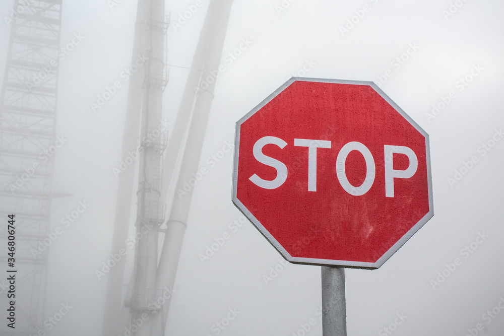Stop road sign in fog