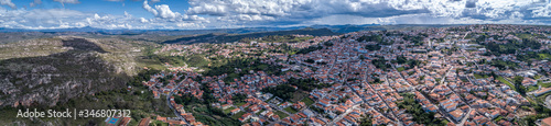 Aerial view panorama with sunshine, shadow, white clouds, rain shower and blue sky of the of historic town Diamantina and mountains, Minas Gerais, Brazil