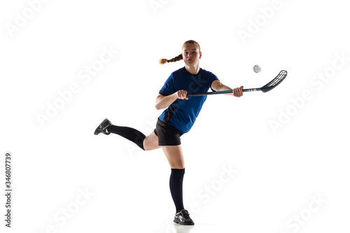 Floorball female player isolated on white studio background. Action and motion, movement, healthy lifestyle and overcoming concept. Young caucasian woman in sportwear training, practicing the game.