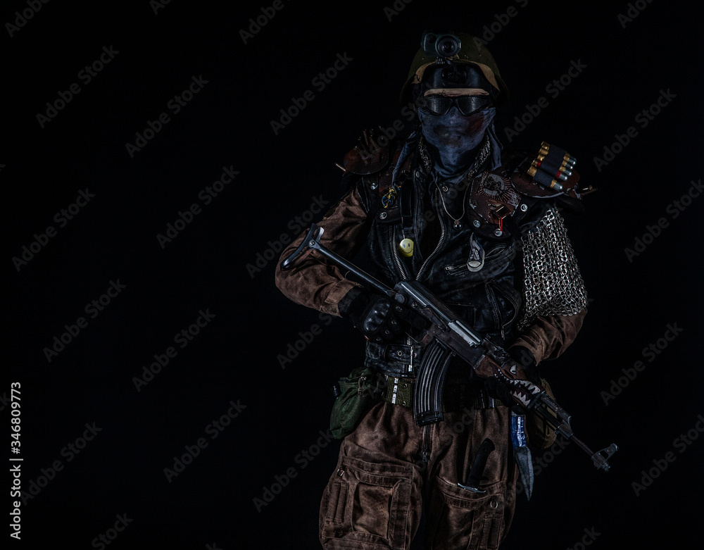 Naklejka premium Nuclear post apocalypse life after doomsday concept. Grimy survivor with homemade weapons. Studio portrait