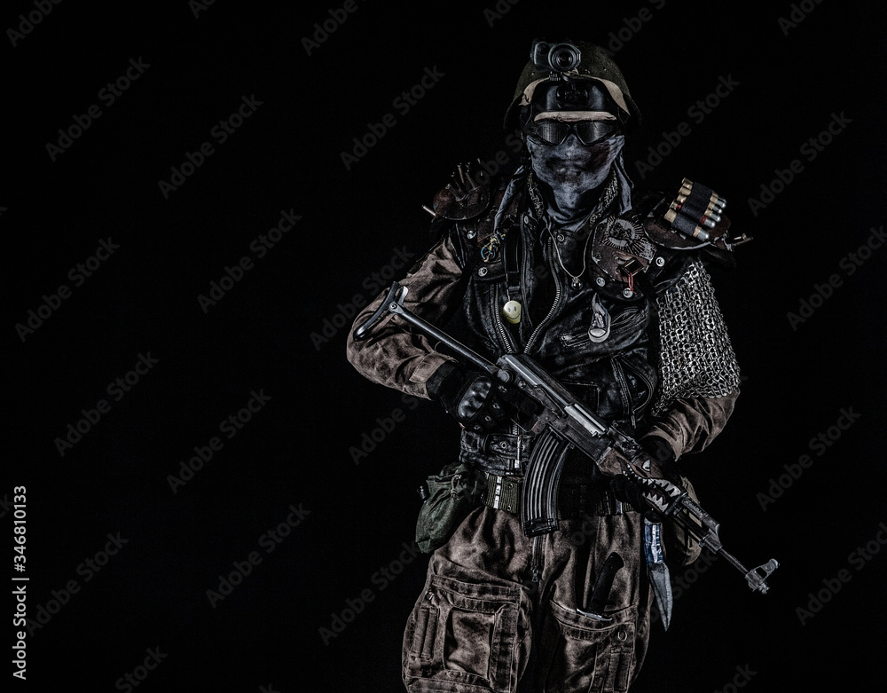 Fototapeta premium Nuclear post apocalypse life after doomsday concept. Grimy survivor with homemade weapons. Studio portrait